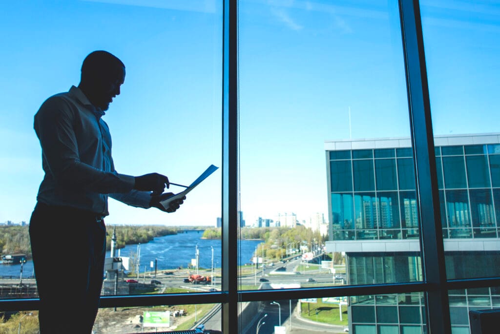 silhouette of a businessman holding a document