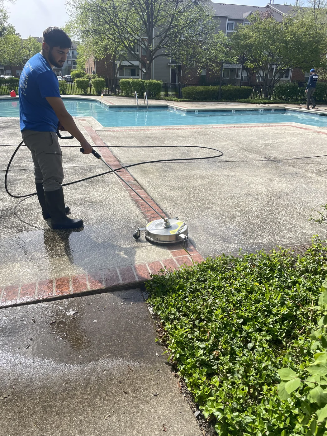 Window Washing Expert technician surface cleaning a concrete pool deck patio